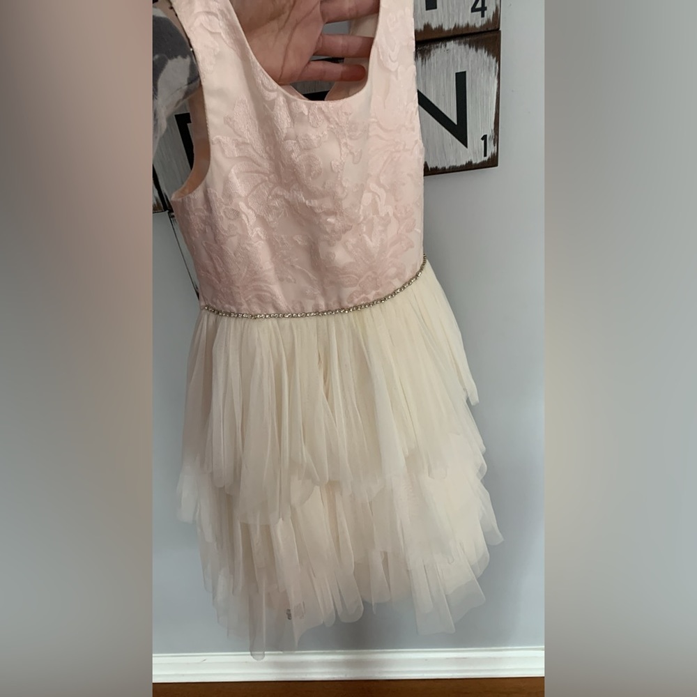 Gorgeous pale pink and cream colored special occasions dress in girls size 8 .